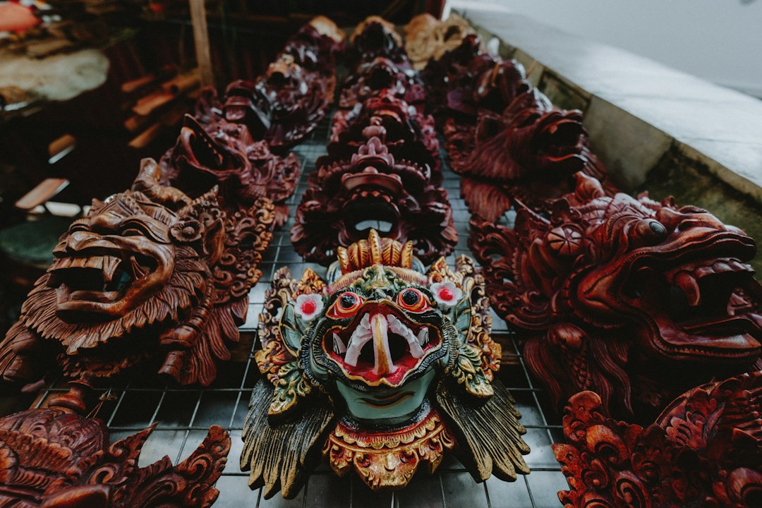 Carved wooden masks for sale at a Bali market stall