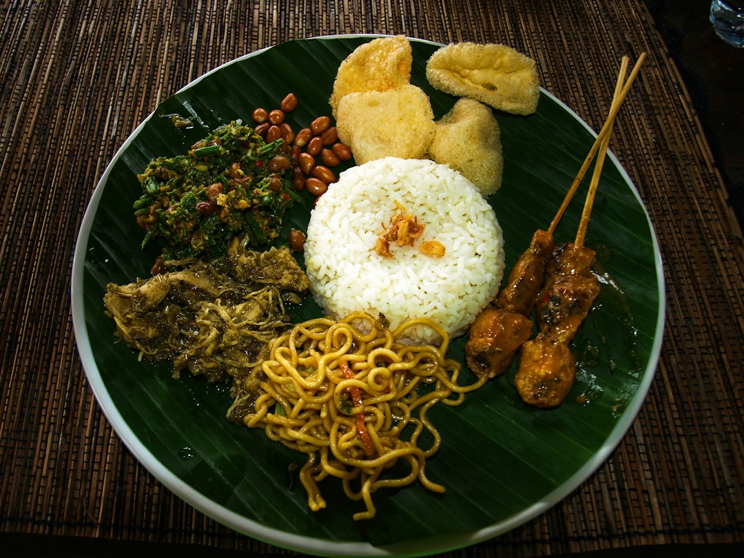 Plate of Indonesian vegetarian food with rice, vegetables and side dishes